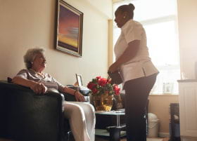 caregiver and old woman talking